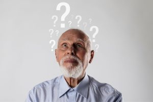 תמונה של אדם קשיש עם סימני שאלה מעליו - כסמל לדמנציה